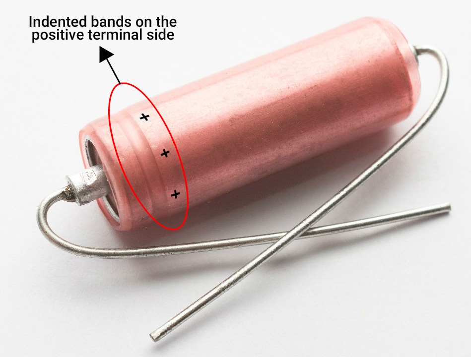 indented-band-on-the-positive-terminal-side-of-an-axial-capacitor.jpg